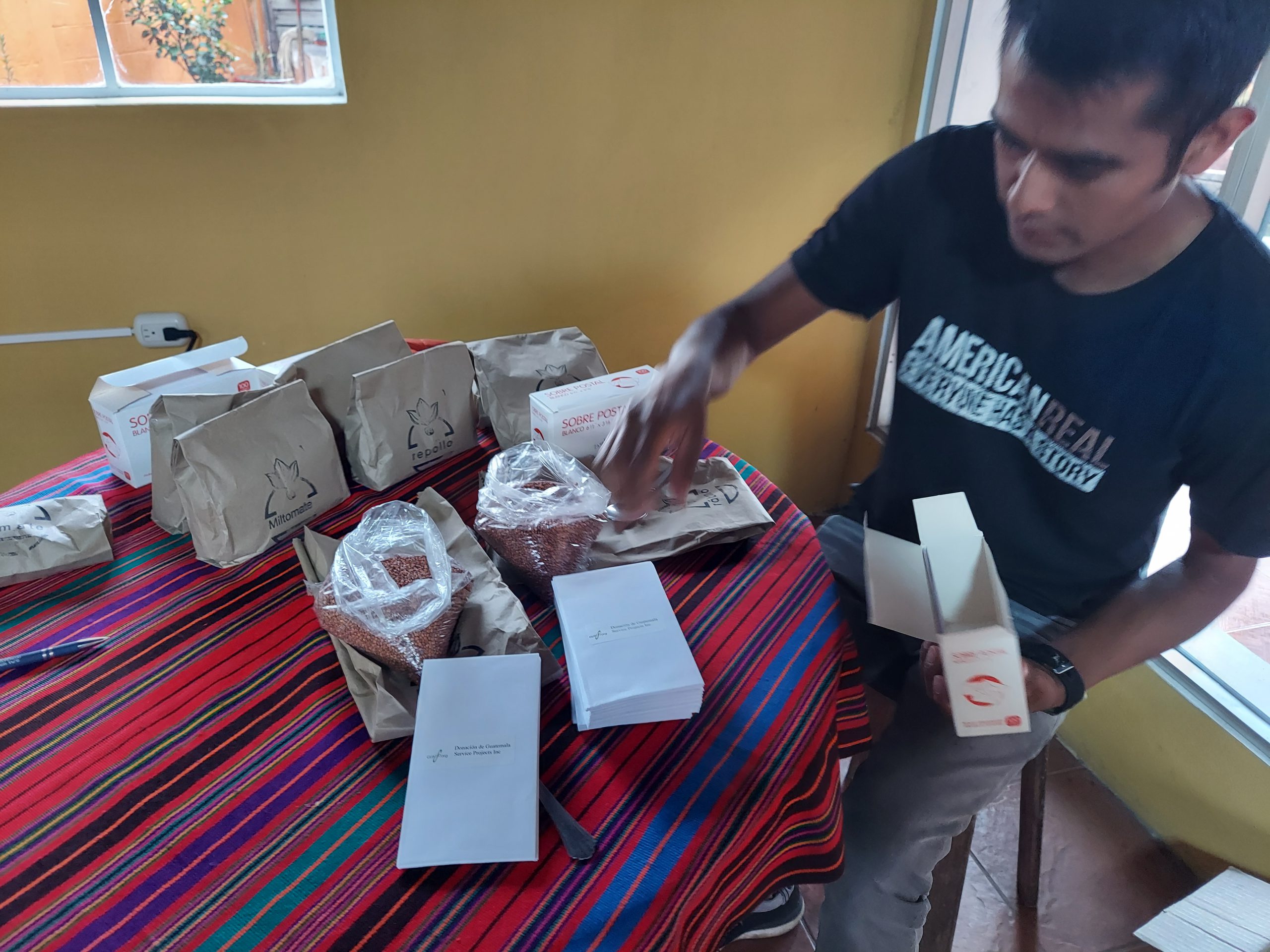 Diego packages seeds for distribution to families in Guatemala